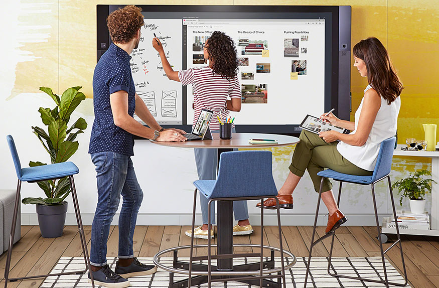 3 young people at whiteboard