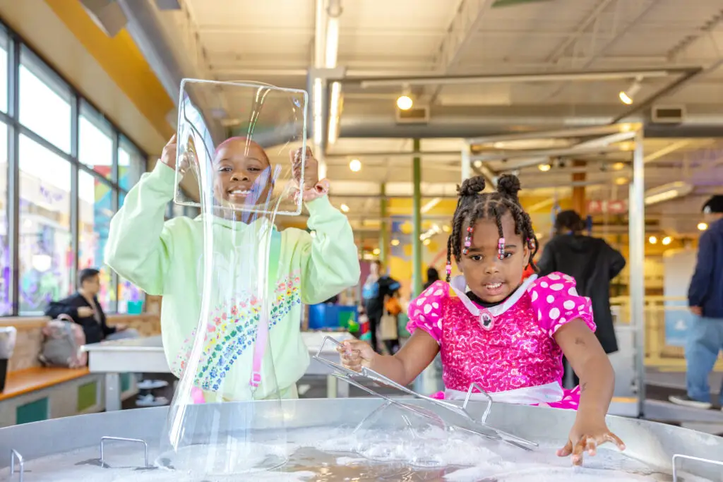 Children playing at a water table at a children's museum