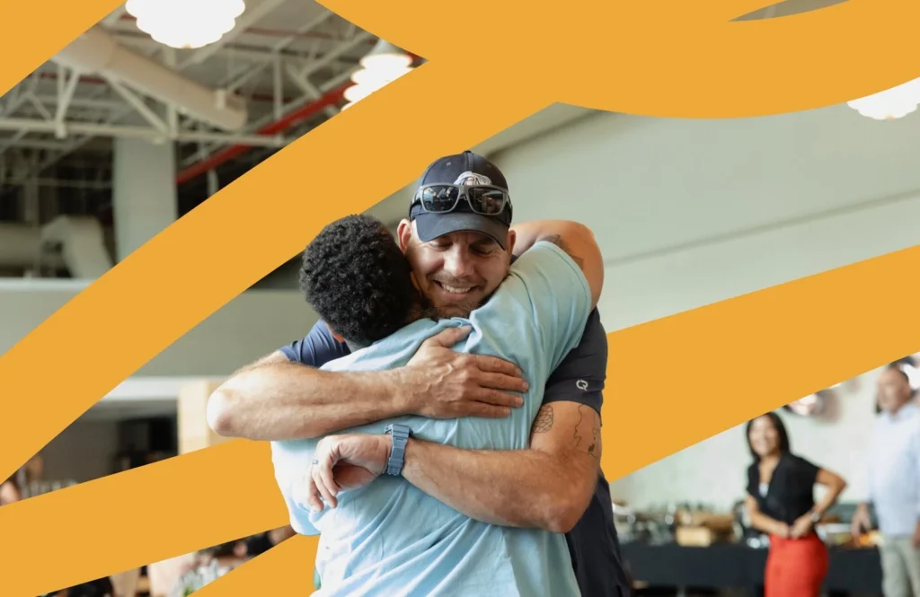 Two people embracing at a Steelcase Foundation event