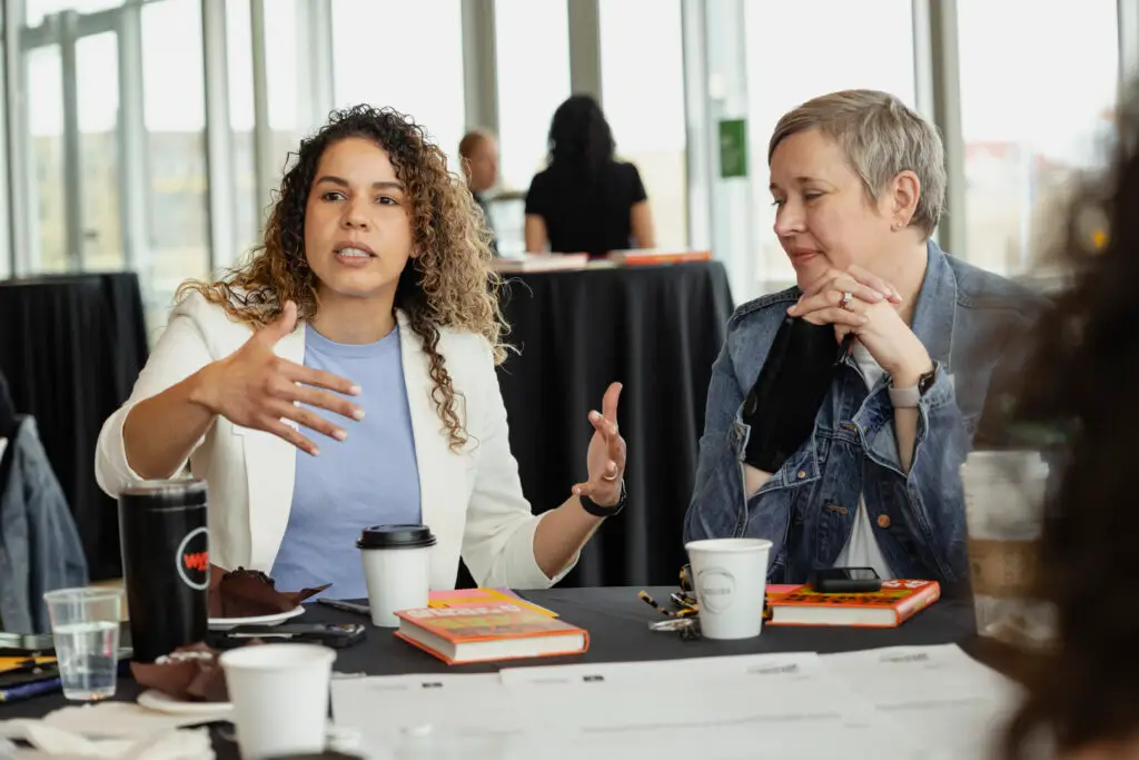 Two women in conversation at the Michigan Children and Families Summit
